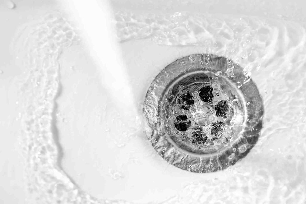 Clear sink drain with water flowing down it